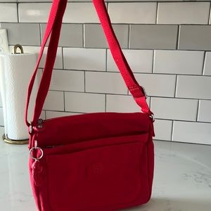 Brand new never used cute Kipling purse with adjustable strap!